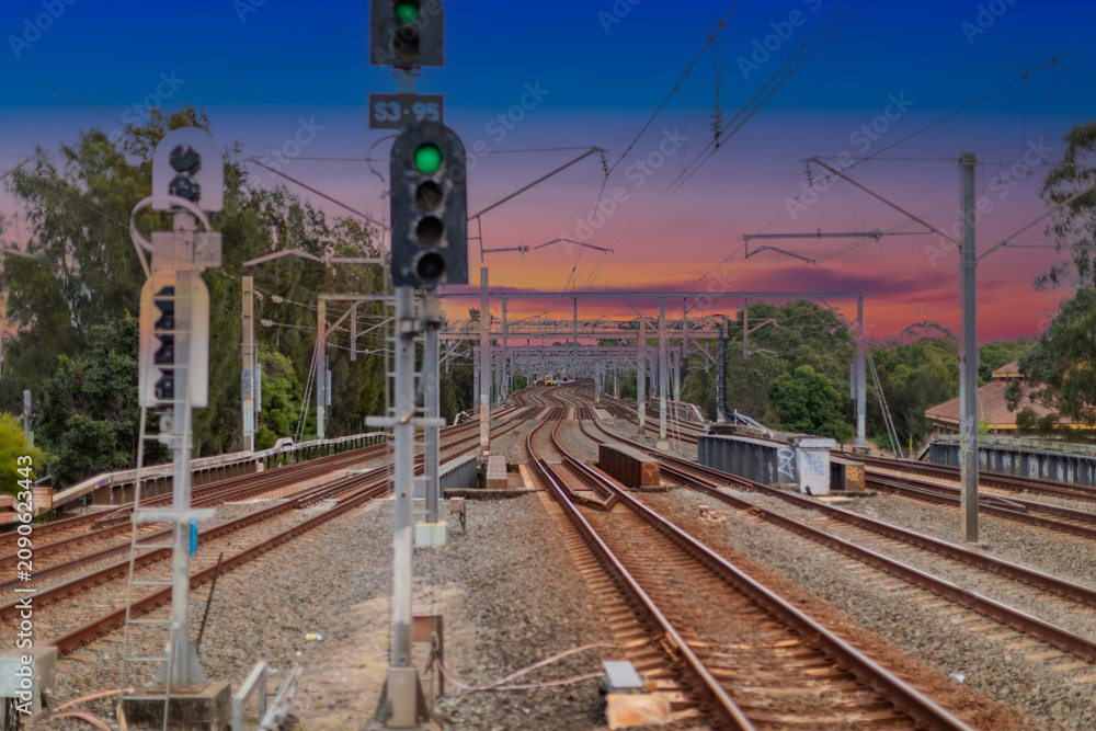 Fototapeta premium 7 July 2026 Passenger Train going through Lewisham Train Station at Sunset a suburban Sydney train Station in Sydney NSW Australia