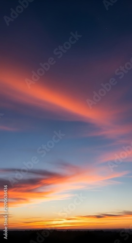 Vibrant Orange and Pink Sunset Clouds Glowing Over Dark Distant Horizon