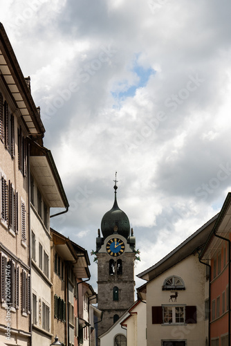 Historic clock tower and traditional buildings in Eglisau, Switzerland