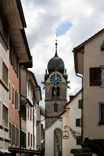 Historic clock tower and traditional buildings in Eglisau, Switzerland