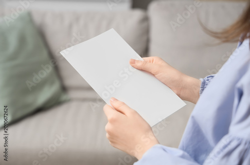 Woman holding a blank white...