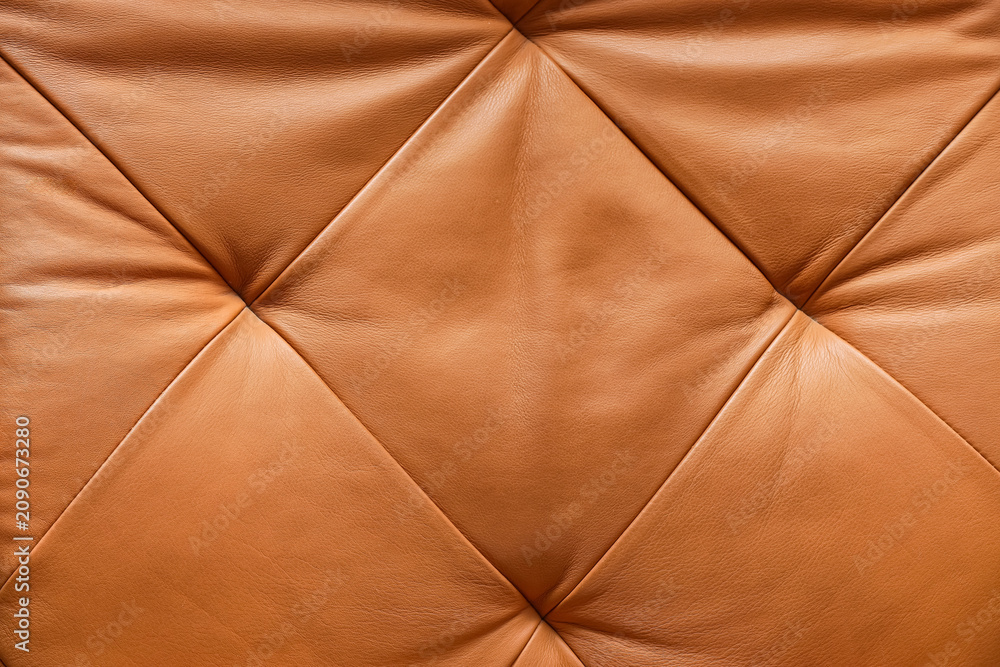 Obraz premium Brown leather upholstery with diamond tufting and textured surface, furniture and interior design background