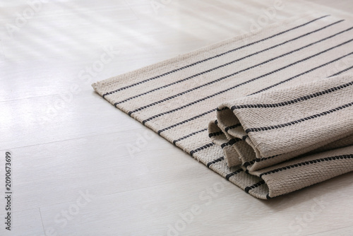 Rolled up striped rug on a ...