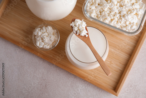 Konstfotografi Glass of fresh kefir and bowls with cottage cheese on white background