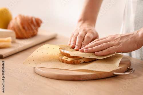 Young woman wrapping tasty ...