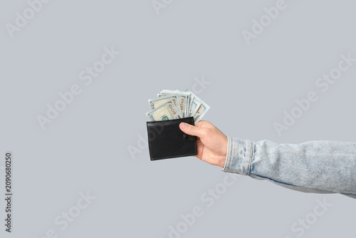 Young man holding wallet wi...