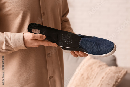 Young man putting black ort...