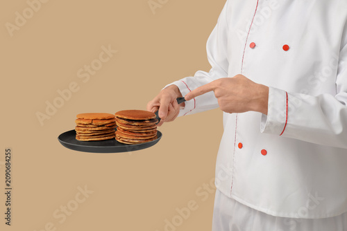 Male chef frying tasty panc...