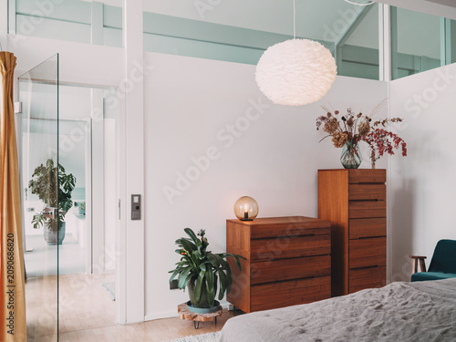 Modern bright bedroom interior in a timber frame construction villa