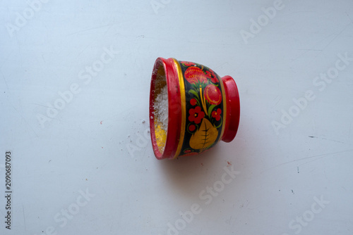Quadro su tela Hand-painted Khokhloma wooden bowl tipped on its side with coarse salt spilling