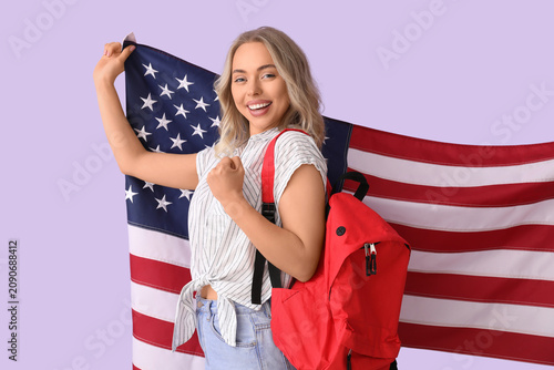 Female student with USA flag on lilac background