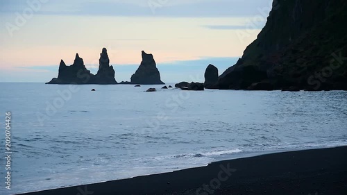 Magical majestic dramatic scenic landscape with Reynisdrangar Sea Cliffs and stones called Troll Fingers under the Reynisfjall Mountain near Vik, Iceland.