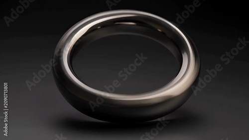 Metallic Torus Ring Floating and Rotating on Black Background