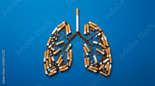 Human lungs shape made of cigarette butts and tobacco on a blue background, creative concept for anti-smoking campaigns and world no tobacco day.