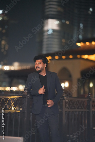 Obraz na płótnie Well-Dressed Young Man Standing Near Burj Khalifa in Downtown Dubai at Night