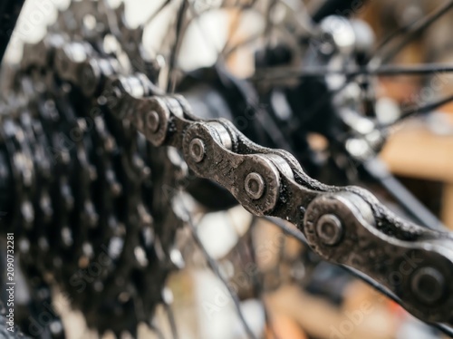 Close Up Dirty Bicycle Chain on Rear Cassette Sprocket with Blurred Background