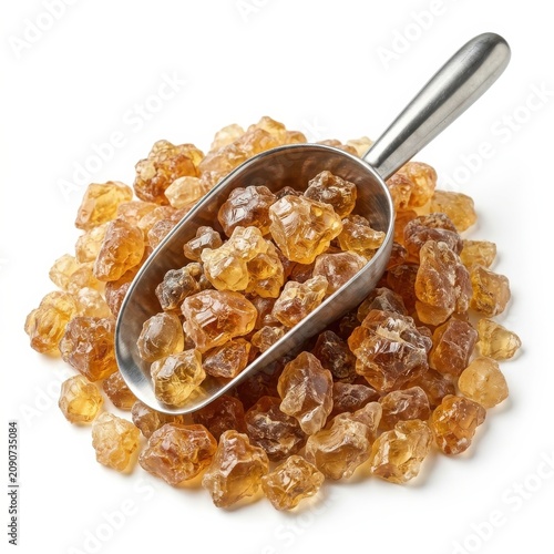 Natural Brown Rock Sugar Crystals in Metal Scoop Isolated on White Background for Culinary and Baking Concepts, Design Space included for Professional Food Content.