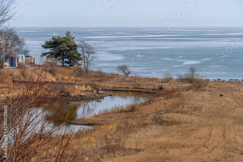 Vászonkép Khanka lake shore with frozen coast in Russia China border during the cold day and sandy beach
