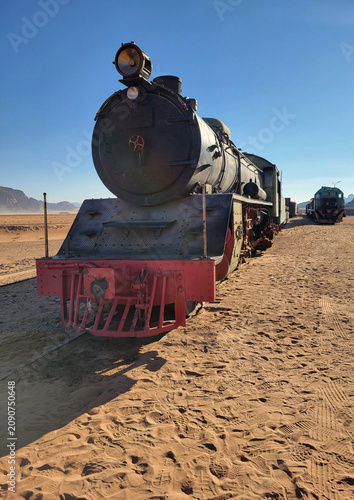 Obraz na płótnie Powerful vertical close-up portrait of a historical Hijaz Railway steam locomotive in the desert of Jordan, near Wadi Rum