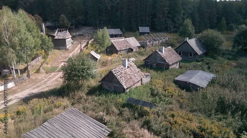 Aerial Drone Flight Over Historic Wooden Village by Lake Surrounded by Forest