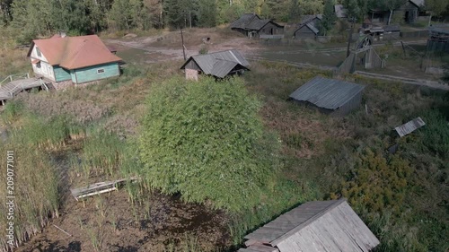 Aerial Drone Flight Over Historic Wooden Village by Lake Surrounded by Forest