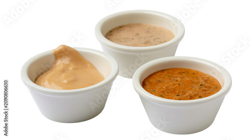 Obraz na plátne Three white ramekins filled with dipping sauces