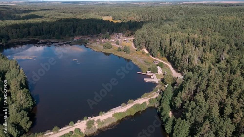 Aerial Drone Flight Over Historic Wooden Village by Lake Surrounded by Forest
