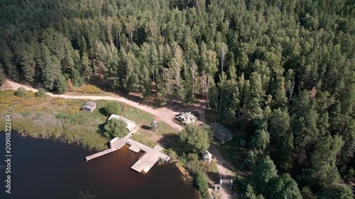 Aerial Drone Flight Over Historic Wooden Village by Lake Surrounded by Forest