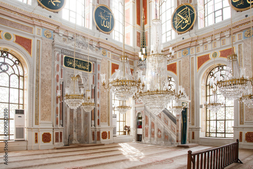 Ornate interior of Ortakoy Mosque with crystal chandeliers and marble mihrab in Istanbul, Turkey