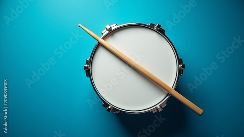 Beautiful modern house creative iteration Drum stick and drum on blue table background top view
