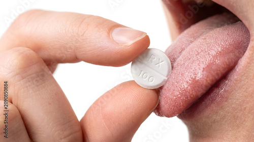 Hand Placing Small White Pill on Person's Tongue Close Up Medical Detail
