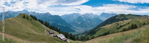 фотографія Large panorama of the Schächen Valley in the canton of Uri in summer with a blue sky and white clouds