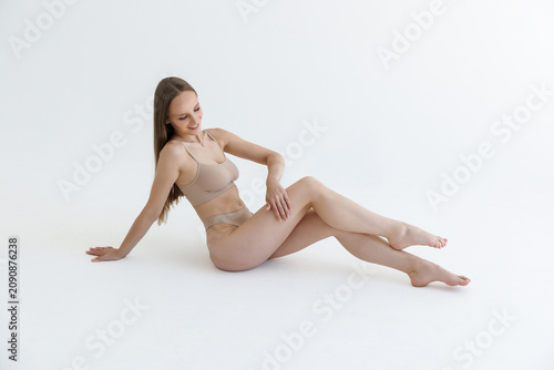 Canvastavla Fashionable photo of young woman wearing beige lingerie in studio