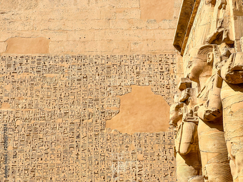 Принти на полотні Beautiful bas-reliefs and ancient hieroglyphs from the mortuary temple of Ramesses III at Medinet Habu, Luxor, Egypt