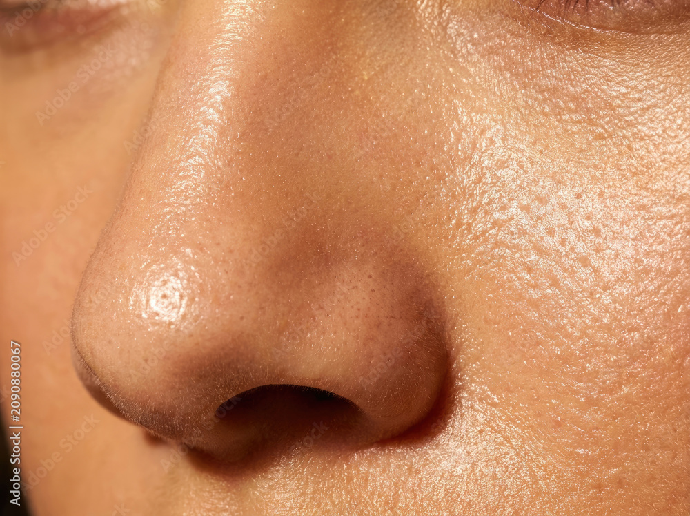 Fototapeta premium Close up of oily skin showing sebum shine and texture details, highlighting skin imperfections