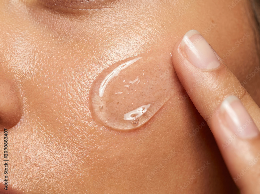 Fototapeta premium Hydrating serum applied on skin, enhancing glow and moisture