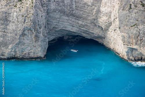 A sightseeing boat at the huge sea grotto in Navagio Bay, Zakynthos Island, Greece.