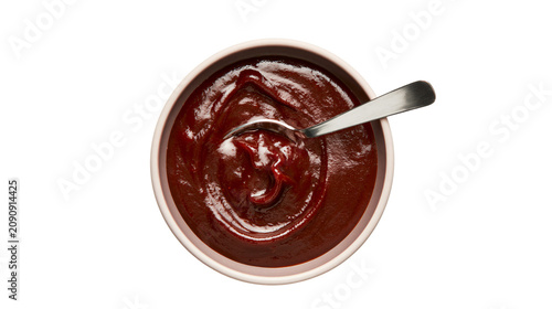 Картината върху платно Thick dark brown barbecue sauce in a bowl with a spoon, isolated on transparent