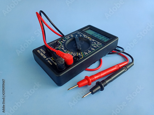 Obraz na płótnie Electronic digital multimeter with probes on blue background