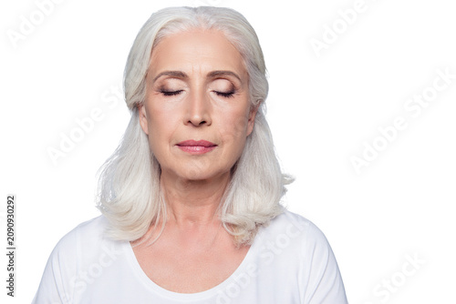 Obraz na plátne Close up portrait of confident concentrated mature woman with wrinkles on face,