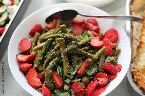 Salad with green asparagus, strawberries, and tomatoes