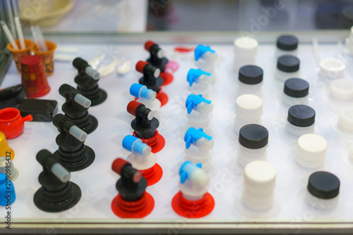 Collection of diverse plastic bottle caps and nozzles in display.