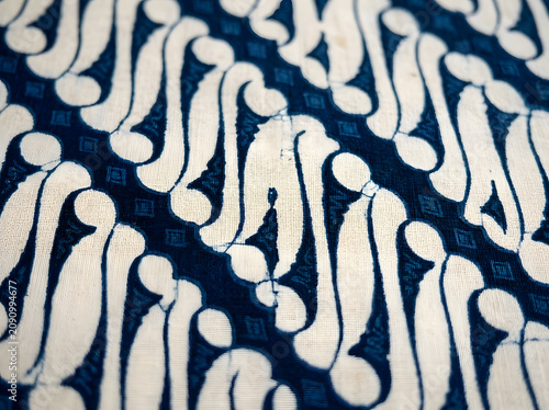 Traditional Javanese batik Parang motif fabric with diagonal knife blade pattern in deep indigo and cream, Indonesian heritage textile