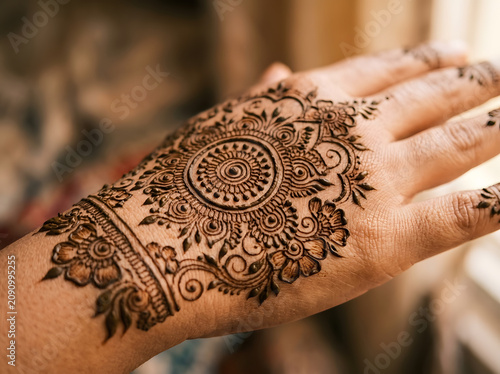 Extreme macro close-up of intricate mehndi henna pattern on hand skin showing detailed mandala design, Indian bridal tradition concept