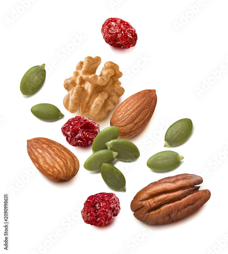 Walnut, pecan and almond nuts, pumpkin seeds, cranberry isolated on white background. Real photography