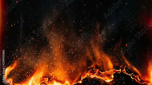 Photos Fiery burning flames with sparks, orange fire line on black background