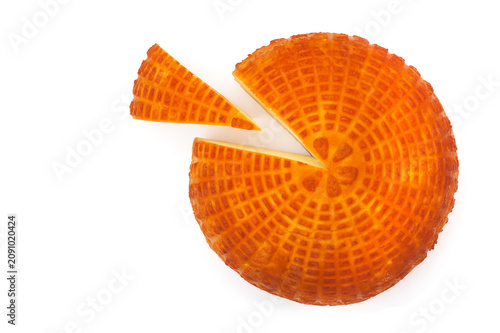 Piece of fresh homemade smoked cheese with a slice on a white background. Top view.