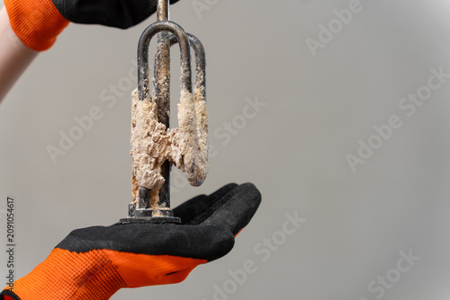 Obraz na płótnie Removed Water Heater Heating Element Covered With Heavy Limescale From Hard Water
