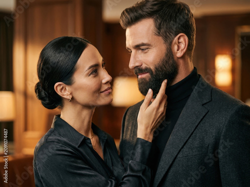 woman admiring a beard touching bearded man's face