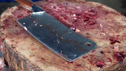 Fotografía Traditional butcher cleaver knife resting on a wooden chopping block used for cutting meat and bones